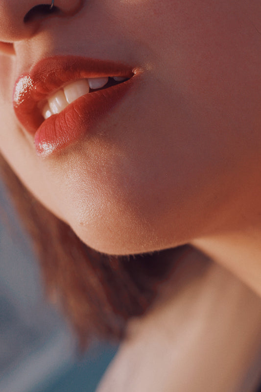 a woman wearing glossy lip balm