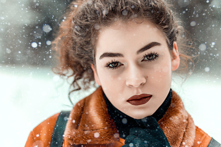 snowfall on a women with makeup in winter