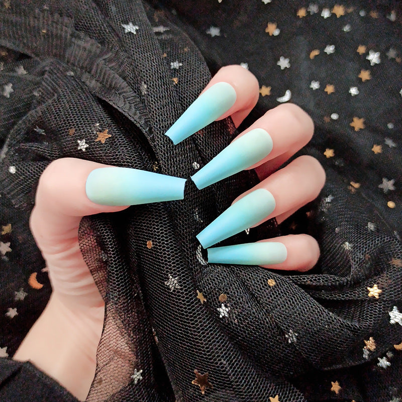fingers wearing blue ombre nails holding a black scarf
