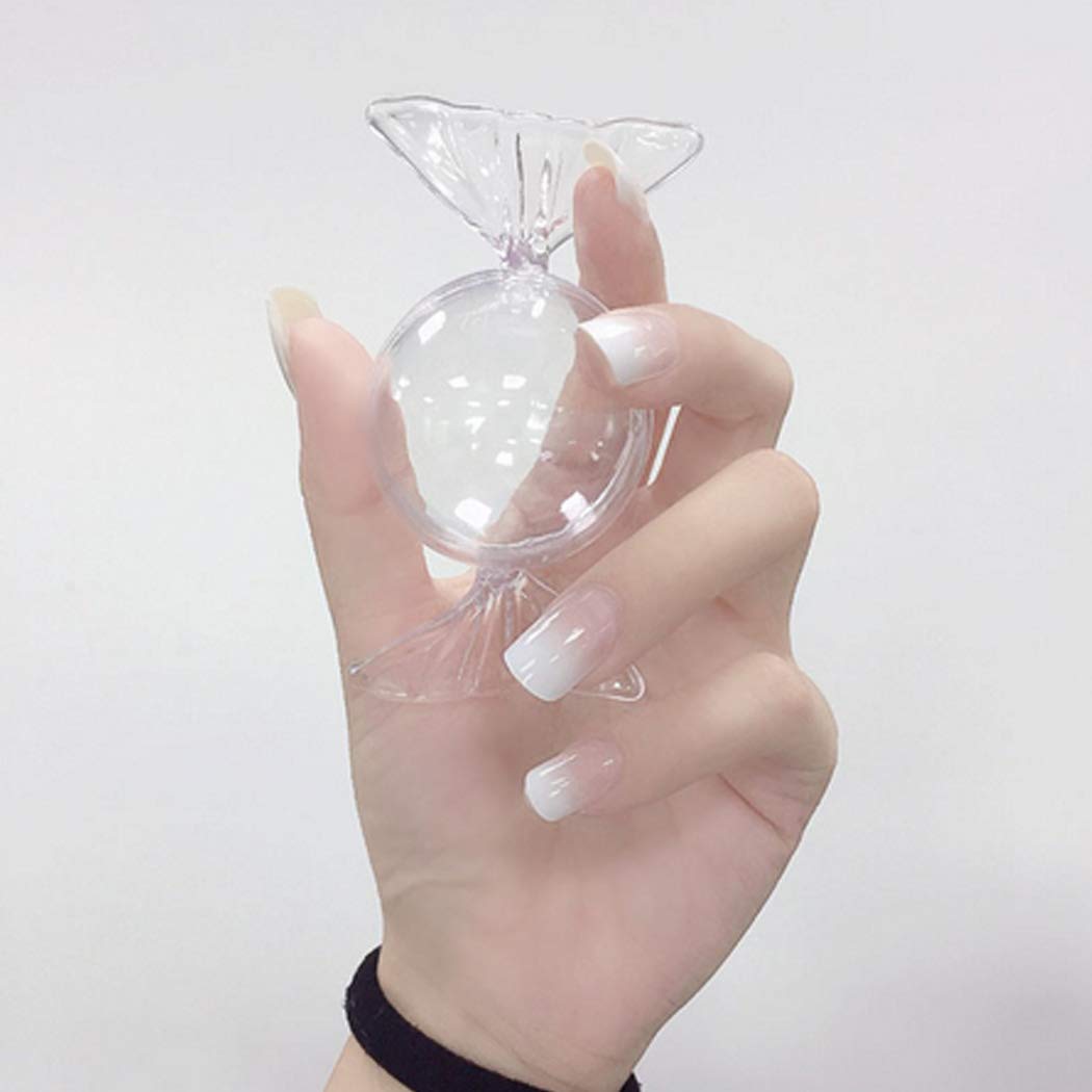 Model's hand wearing white ombre nails is holding a transparent craft.